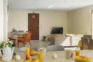 a living room with a table with food on it at La Maison Dorée in Porto Santo