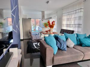 a living room with a couch with blue pillows at Thermenblick in Bad Aibling