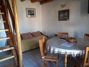 a living room with a table and a couch at La Perlita de Trevelin in Trevelín