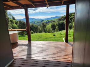 a wooden porch with a view of a mountain at Glenwood Akaroa Bush Retreat - Kanuka Hut in Akaroa