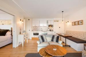 a living room with a couch and a table at Summit Serenity in Queenstown