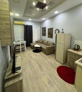 a living room with a couch and a refrigerator at Aura Apartaments 2 in Tirane