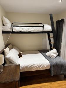 a bedroom with two bunk beds and a table at Summit Serenity in Queenstown