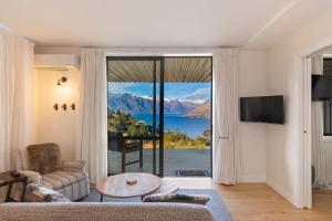 a living room with a view of the mountains at Summit Serenity in Queenstown