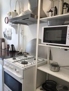a kitchen with a white stove and a microwave at Quiet room in lively area with helpful Host! in Copenhagen +26 photos