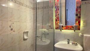 a bathroom with a shower with a sink and a toilet at Complejo Aguazul in La Pedrera +35 photos