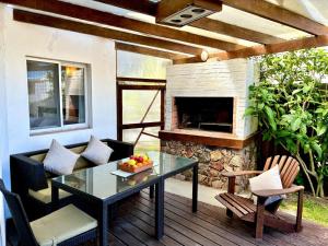 a patio with a table and a fireplace at Complejo Aguazul in La Pedrera