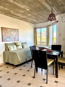 a bedroom with a bed and a table and a dining room at Complejo Aguazul in La Pedrera