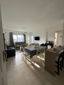 a living room with a table and chairs and a couch at Croeso! in Puerto Madryn