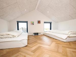 2 Betten in einem Zimmer mit Holzboden in der Unterkunft 5 star holiday home in Løkken in Løkken