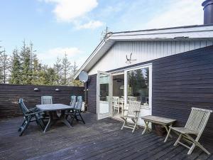 a patio with a table and chairs on a deck at 5 person holiday home in Hals-By Traum in Hals