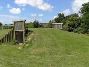 two fences in a field with grass and trees at Luxury Retreat with Spa - By Traum Ferienwohnungen in Hemmet