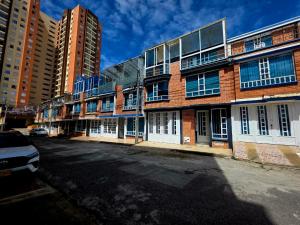 a brick building with windows on a city street at Studio Norte Tunja Moderno y acogedor in Tunja