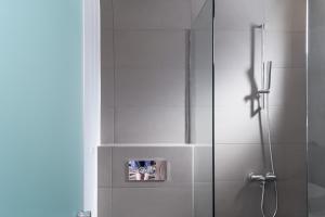 a bathroom with a shower with a glass door at Semeli in Kokkari +33 photos