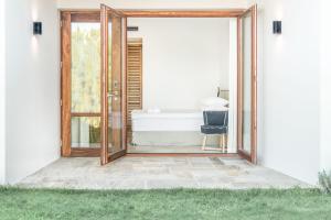 an open door to a bathroom with a tub at Semeli in Kokkari
