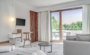 a living room with a couch and a large window at Semeli in Kokkari