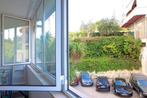 a group of cars parked outside of a window at Casa Miel en el Botánico in Tirana
