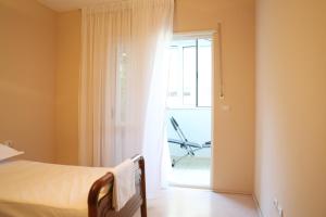 a bedroom with a bed and a sliding glass door at Casa Miel en el Botánico in Tirana +29 photos