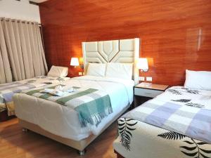 a hotel room with two beds and two lamps at Estela de Oro Hotel Boutique in Arequipa +37 photos