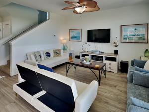 a living room with a couch and a tv at So Serene in Galveston