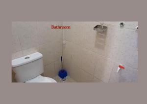 a bathroom with a white toilet in a room at PRAISE PLACE - Heritage 7 Apartments in Ijebu Ode