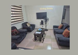 a living room with couches and a tv at PRAISE PLACE - Heritage 7 Apartments in Ijebu Ode