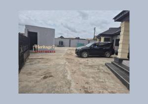 a car parked in the driveway of a house at PRAISE PLACE - Heritage 7 Apartments in Ijebu Ode