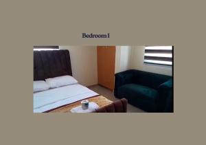 a room with a bed and a couch and a chair at PRAISE PLACE - Heritage 7 Apartments in Ijebu Ode