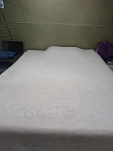 a large white bed sitting in a room at house cop30 in Ananindeua