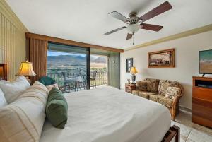 a bedroom with a large bed with a ceiling fan at Lahaina Shores 512 · LS 512 Getaway Studio by the Beach Pool Hot in Lahaina +45 photos