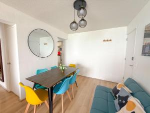 a dining room with a table and blue chairs at Nuevo exclusivo con vista al mar - Blue One in Lima