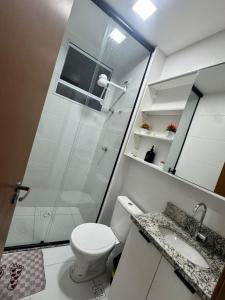 a bathroom with a shower and a toilet and a sink at Reserva Almagre Apto 403 in Cabedelo +24 photos