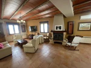 a living room filled with furniture and a fireplace at El Fontanar de Peñarrubia in Peñarrubia