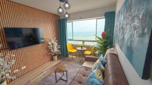 a living room with a couch and a view of the ocean at Nuevo exclusivo con vista al mar - Blue One in Lima
