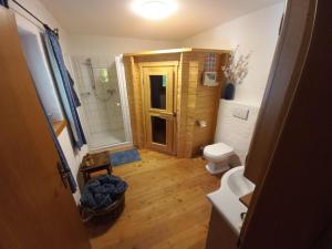 a small bathroom with a toilet and a shower at Landhaus Finkenhof in Untertschern +25 photos
