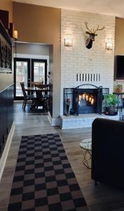 a living room with a fireplace and a table at Stag & Sparrow in Salem