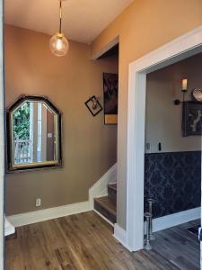 a hallway with a mirror and stairs in a house at Stag & Sparrow in Salem