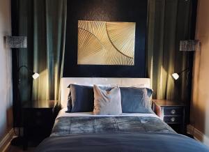 a bedroom with a large bed with blue pillows at Stag & Sparrow in Salem