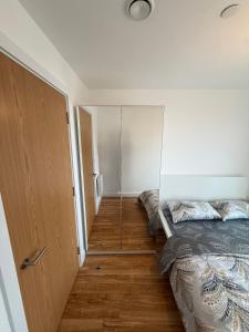 a small bedroom with a bed and a closet at A s Crib in Manchester