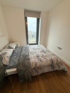 a bedroom with a bed with a large window at A s Crib in Manchester