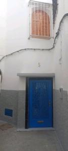 a blue door on the side of a building at DAR TAZROUT in Tangier