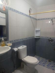 a bathroom with a toilet and a sink at Dar Mobarak in Oualidia