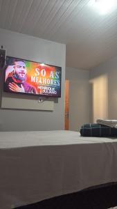 a flat screen tv on a wall above a bed at Hospedaria Tapajós in Santarém +10 photos