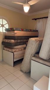 a room with a large stack of logs at Casa de praia em Peruibe com muito verde! in Peruíbe