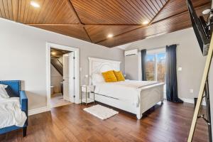 a bedroom with a white bed and a wooden ceiling at Vista Del Mar 596 in Hubbards