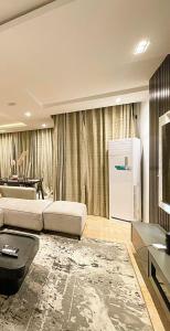 a living room with a couch and a refrigerator at IBIZA LAGoS in Lagos