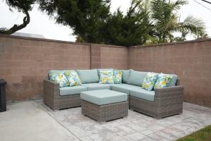 a wicker couch with pillows on a patio at Destination #16 in Anaheim