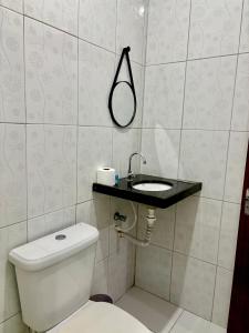 a bathroom with a toilet and a sink at Temporada AK Freitas in Parnaíba