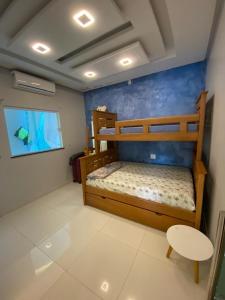 a bedroom with two bunk beds and a tv at Casa por temporada in Barreirinhas +13 photos