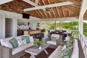 an outdoor living room with a couch and a table at Bohemia Two Bedroom home in James Cistern